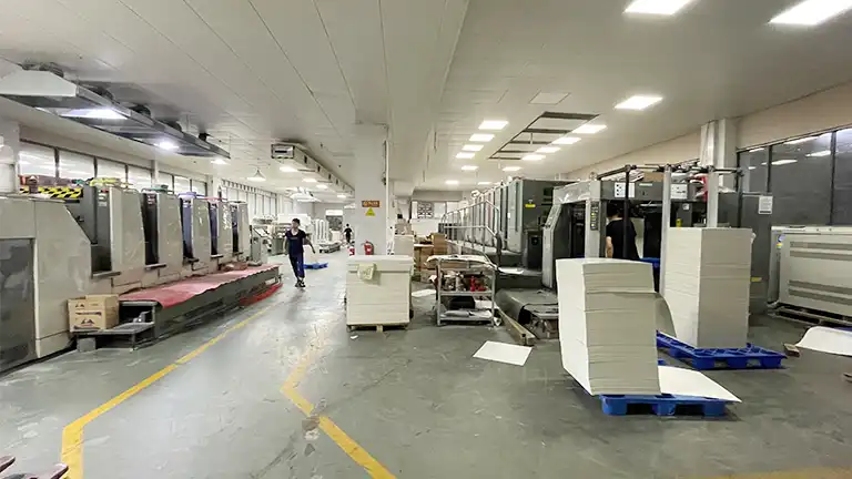 Printing production facility, industrial machines and stacked paper ready for packaging