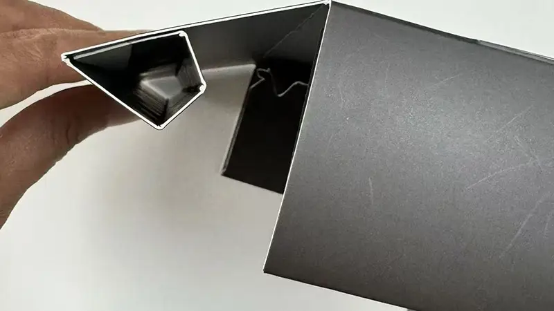 Close-up of a folded paper box edge, demonstrating sturdy triangular construction and premium material.
