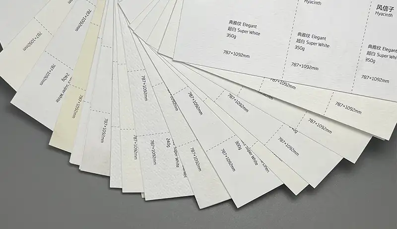 A selection of white textured papers with varying surface finishes