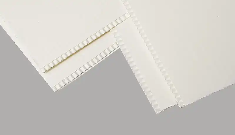 Close-up of white F flute corrugated boards with sharp fine fluting
