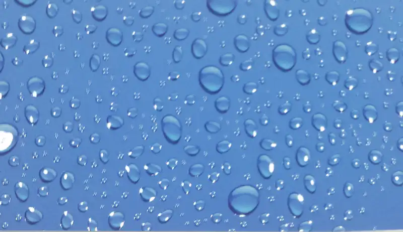 Water droplet texture created using 3D spot UV printing on blue surface.