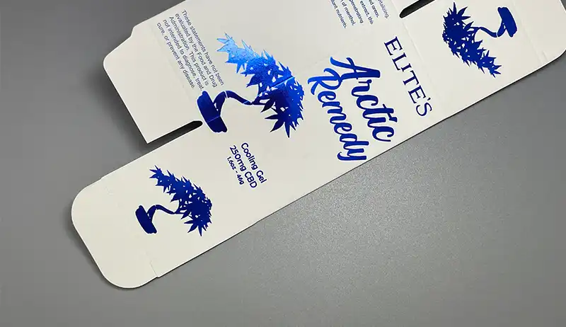 Blue foil stamping on white folding carton with crisp details.