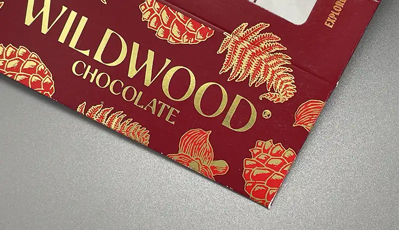 Red packaging box with metallic gold foil stamped logo and pattern.