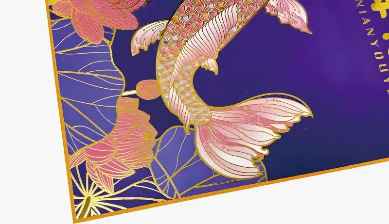 Gold foil stamped koi fish with lotus on luxury packaging surface