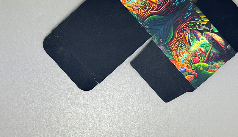 A black paperboard box with vivid artwork and soft touch lamination.
