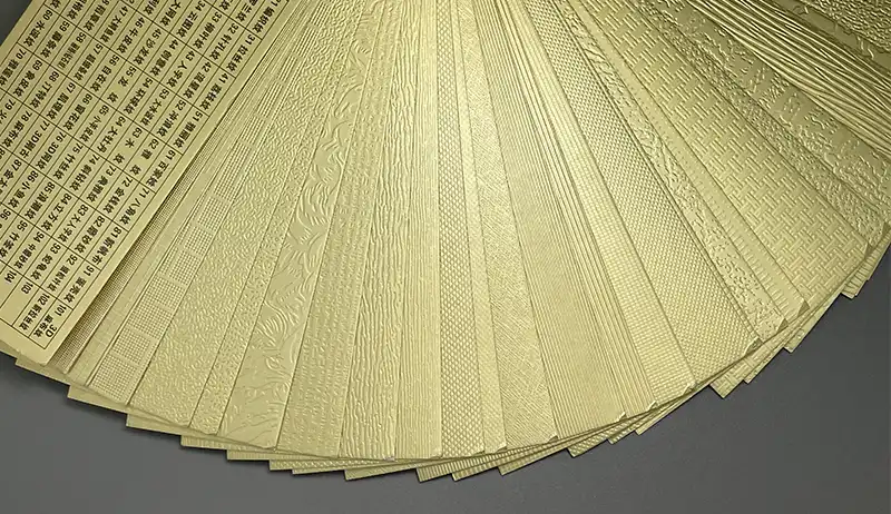 Fan deck of textured gold foil samples showcasing various surface styles.