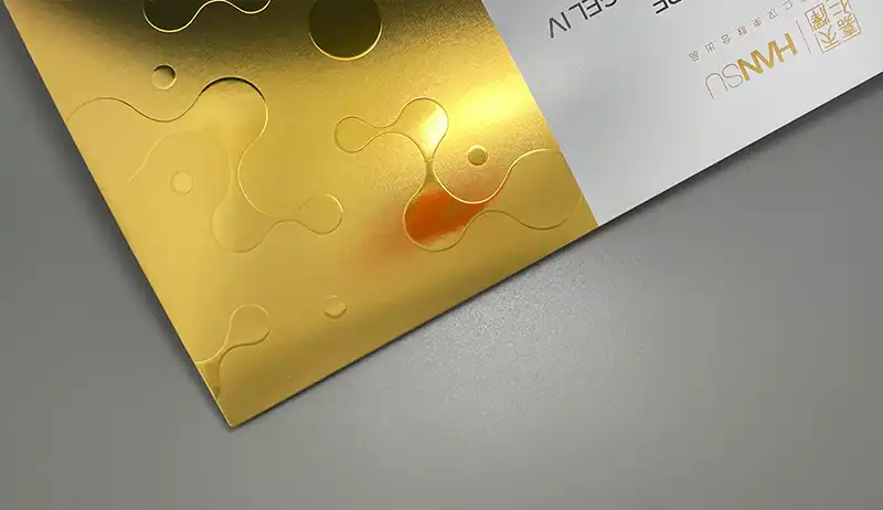 Gold UV varnish with raised spot texture on premium printed packaging.
