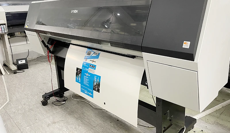 Epson large-format digital printing machine printing a color sheet