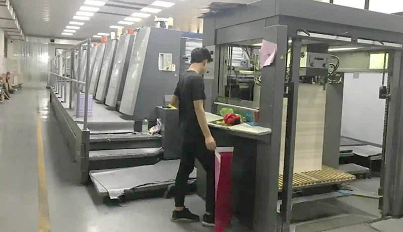 Heidelberg offset printing machine in operation with technician nearby