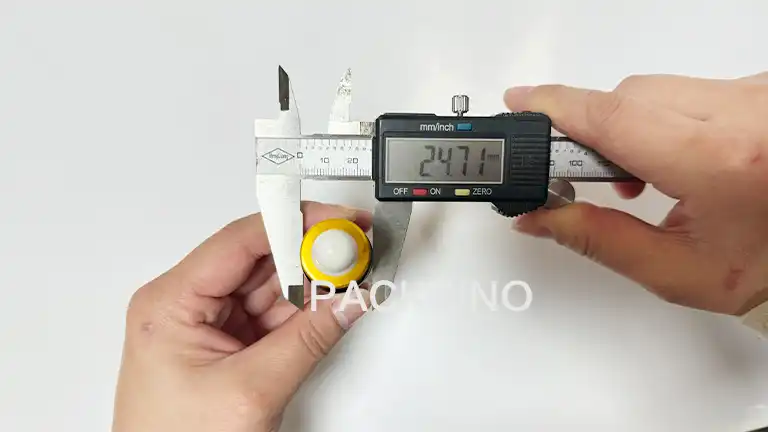 Measuring bottle width with caliper for packaging customization
