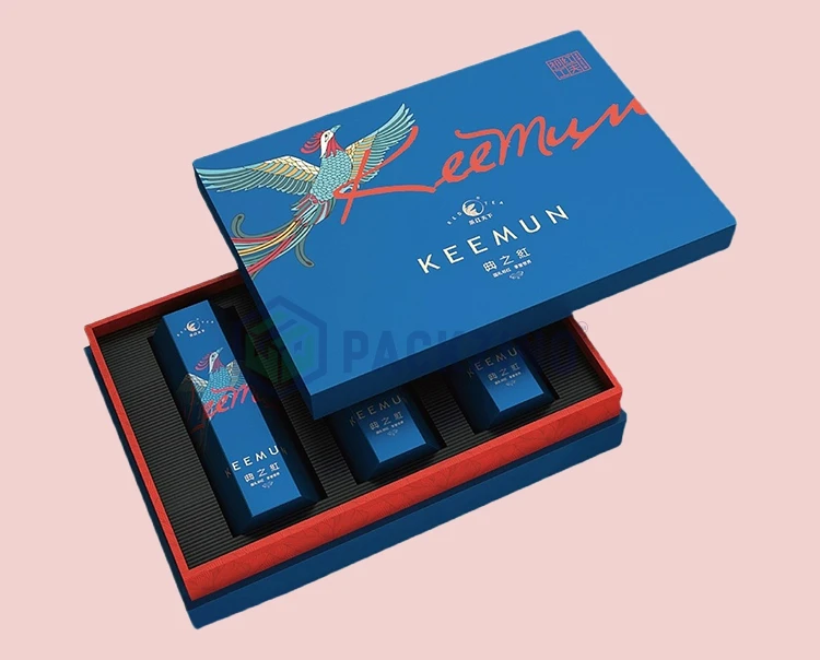 Custom box insert design using fluted cardboard tray holds multiple tea boxes in a rigid gift box.