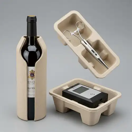 Molded pulp protective packaging insert safely holds wine, tools, and electronic devices.