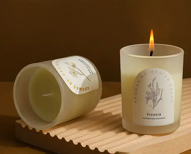 Custom candle labels on glass jars for scented freesia candles