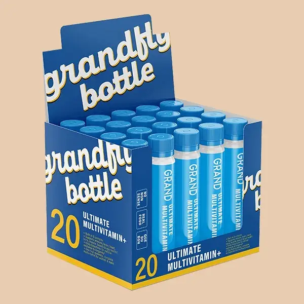 A custom cardboard display box holding vitamin bottles on a retail shelf