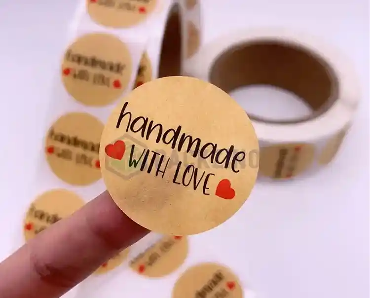 Custom kraft paper labels with "handmade with love" text in roll format