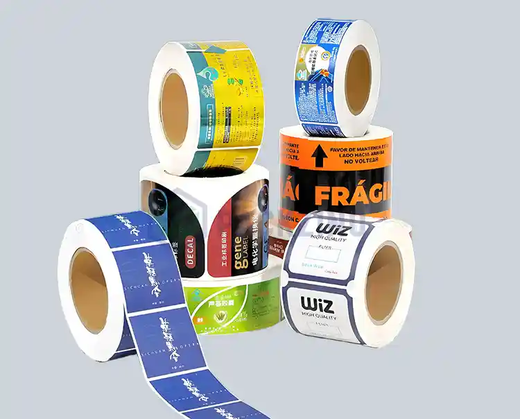 Assorted custom label rolls with various sizes, shapes, and colors for product and shipping use