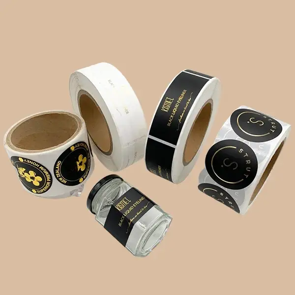 A variety of custom printed roll labels in black and gold for product use