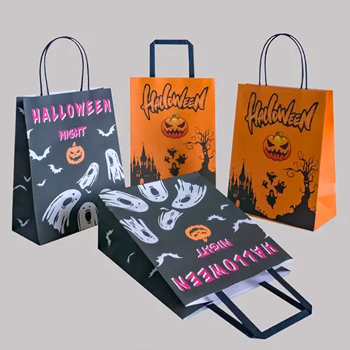 Custom printed retail paper bags with Halloween designs and twisted handles.