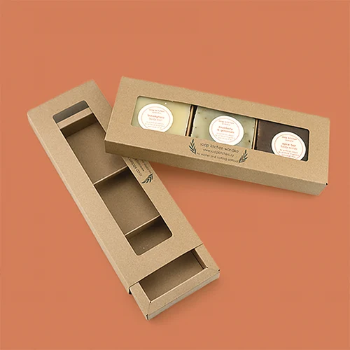 Kraft sustainable soap packaging with window and insert on orange background