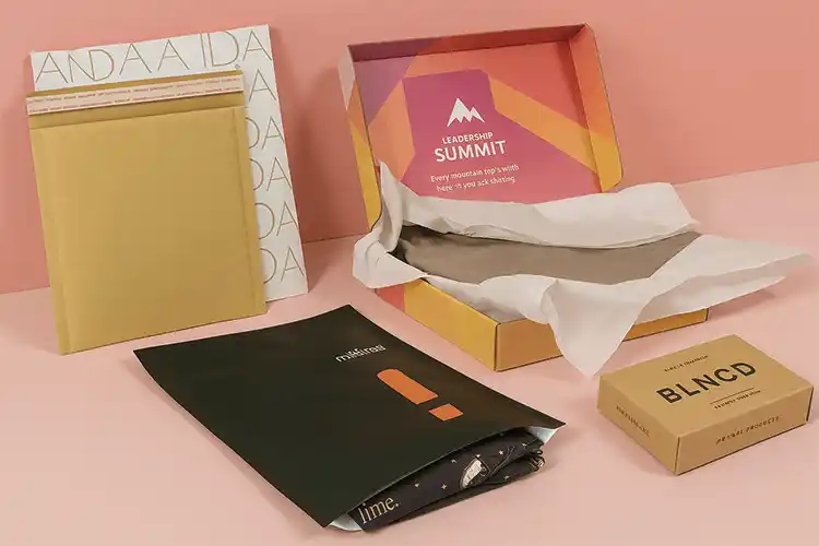 Custom apparel packaging set including mailer envelopes, folding cartons, and small accessory boxes
