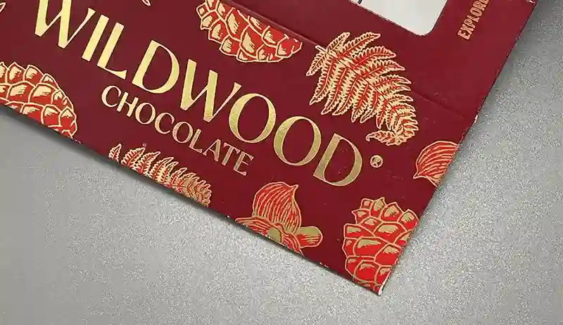Red packaging box with metallic gold foil stamped logo and pattern.