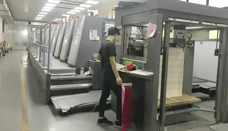 Heidelberg offset printing machine in operation with technician nearby