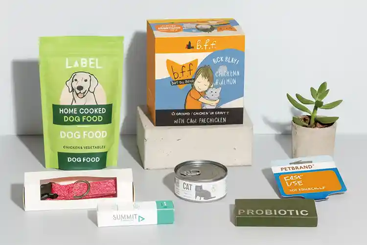 Assorted pet product packaging including cartons, pouches, and labels