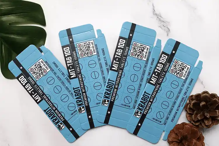 Flat-lay nutraceutical folding cartons with QR codes and printed dosage info, ready for folding.