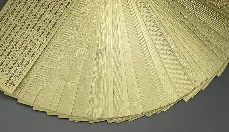 Fan deck of textured gold foil samples showcasing various surface styles.