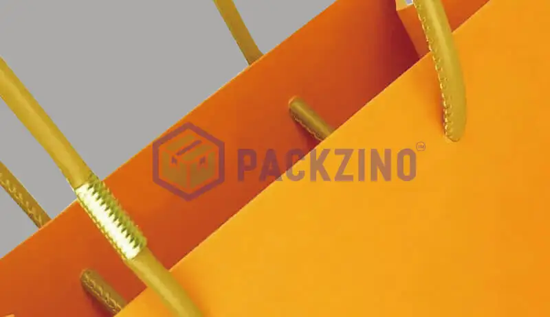 Orange paper bag with flat handle and clear plastic reinforcements