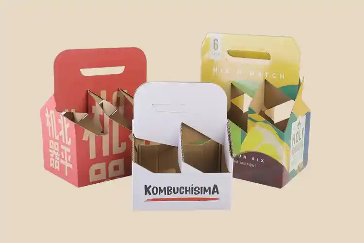 Three colorful corrugated bottle carrier boxes designed for food and beverage packaging.