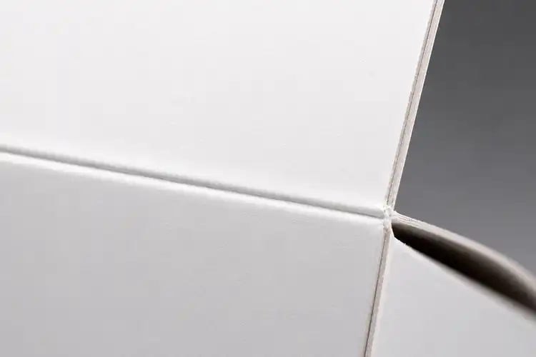 SBS paperboard folding crease with smooth clean surface and almost invisible cracking under folding stress